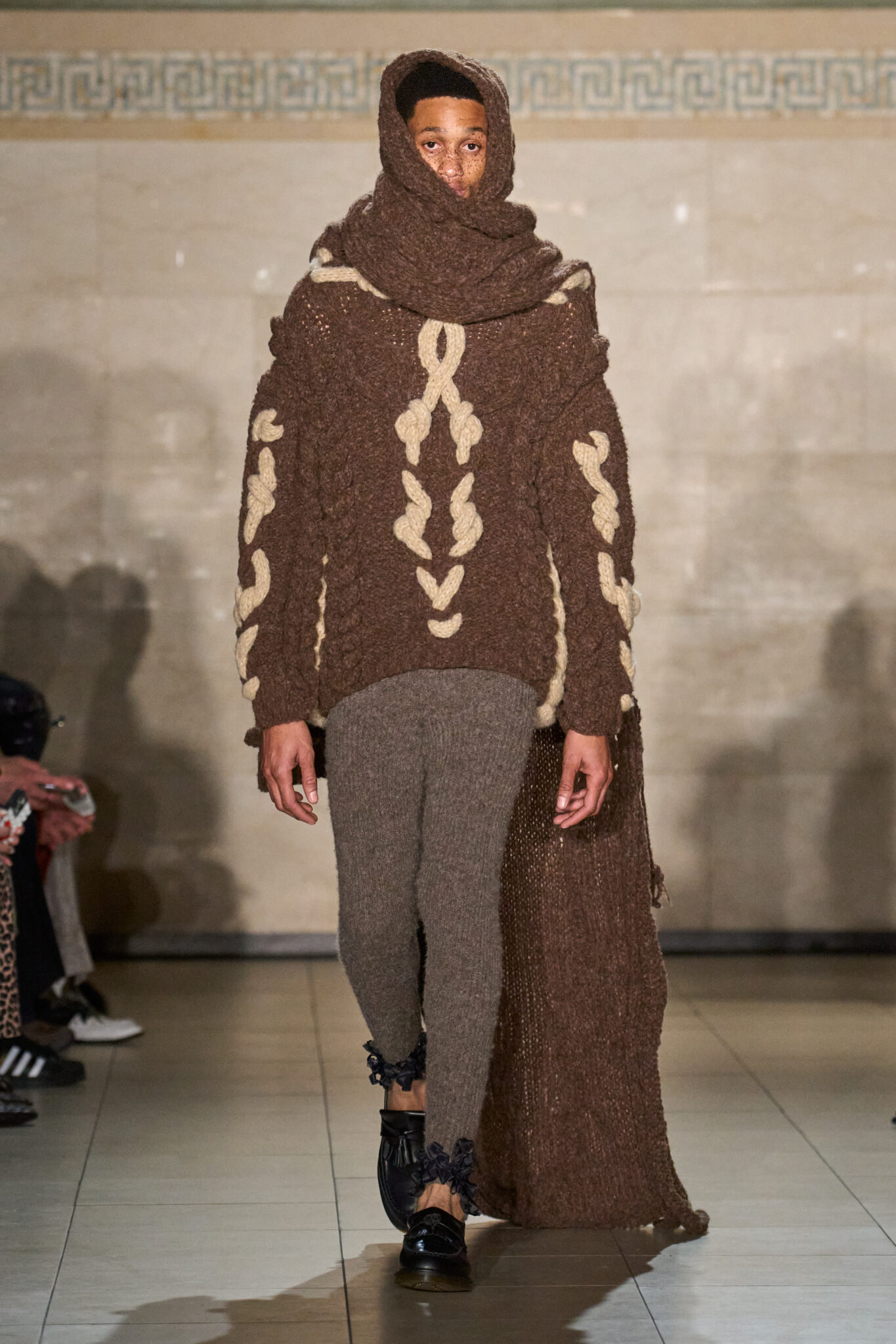 Runway look: brown knit hooded sweater with brown trousers, Meruert Tolegen Fall/Winter 2025
