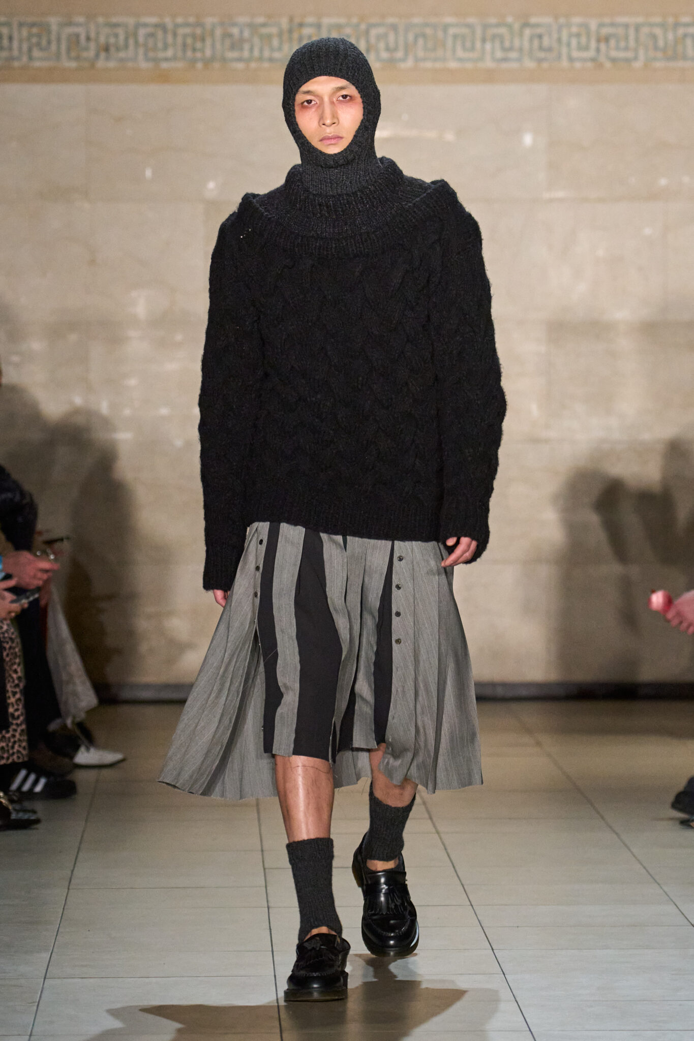 Runway look: black hooded knit top with a grey skirt, Meruert Tolegen Fall/Winter 2025