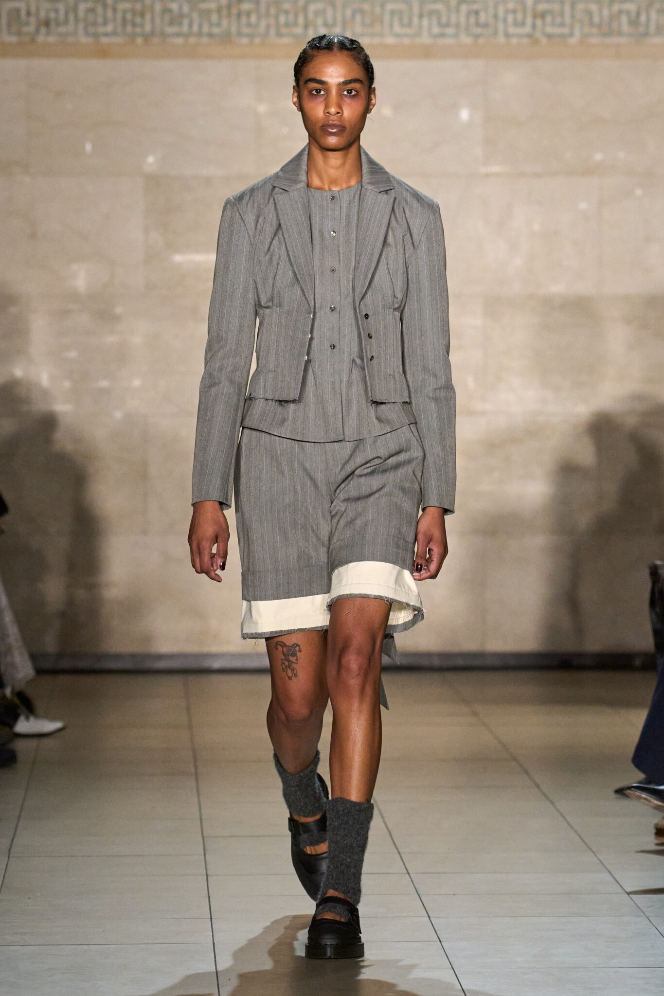 Runway look: grey tailored jacket with a mini skirt, Meruert Tolegen Fall/Winter 2025