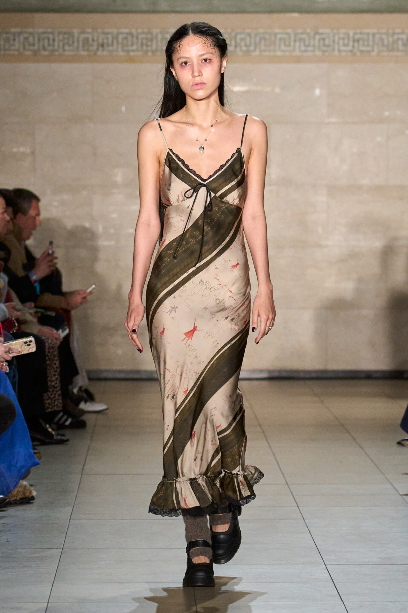 Runway look: long gold and black striped slip dress, Meruert Tolegen Fall/Winter 2025